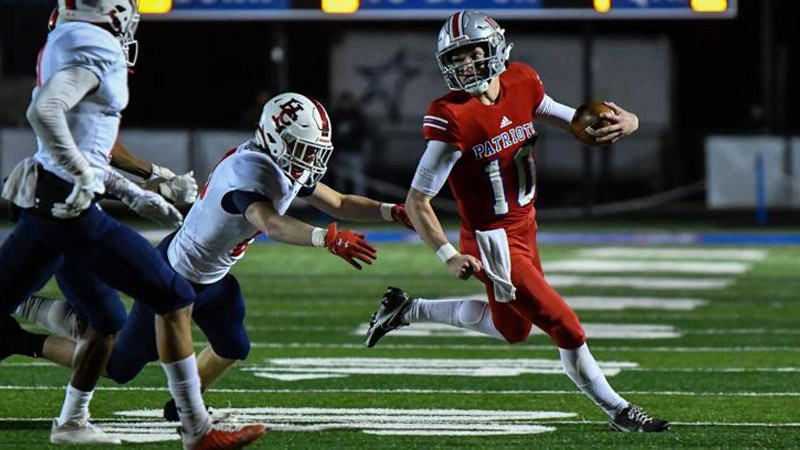 Football Players Run Through The Middle