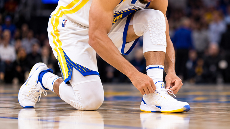 Why Do NBA Players Touch Their Shoes During Games